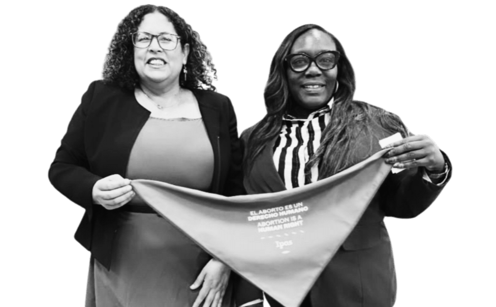 Two women holding a bandana